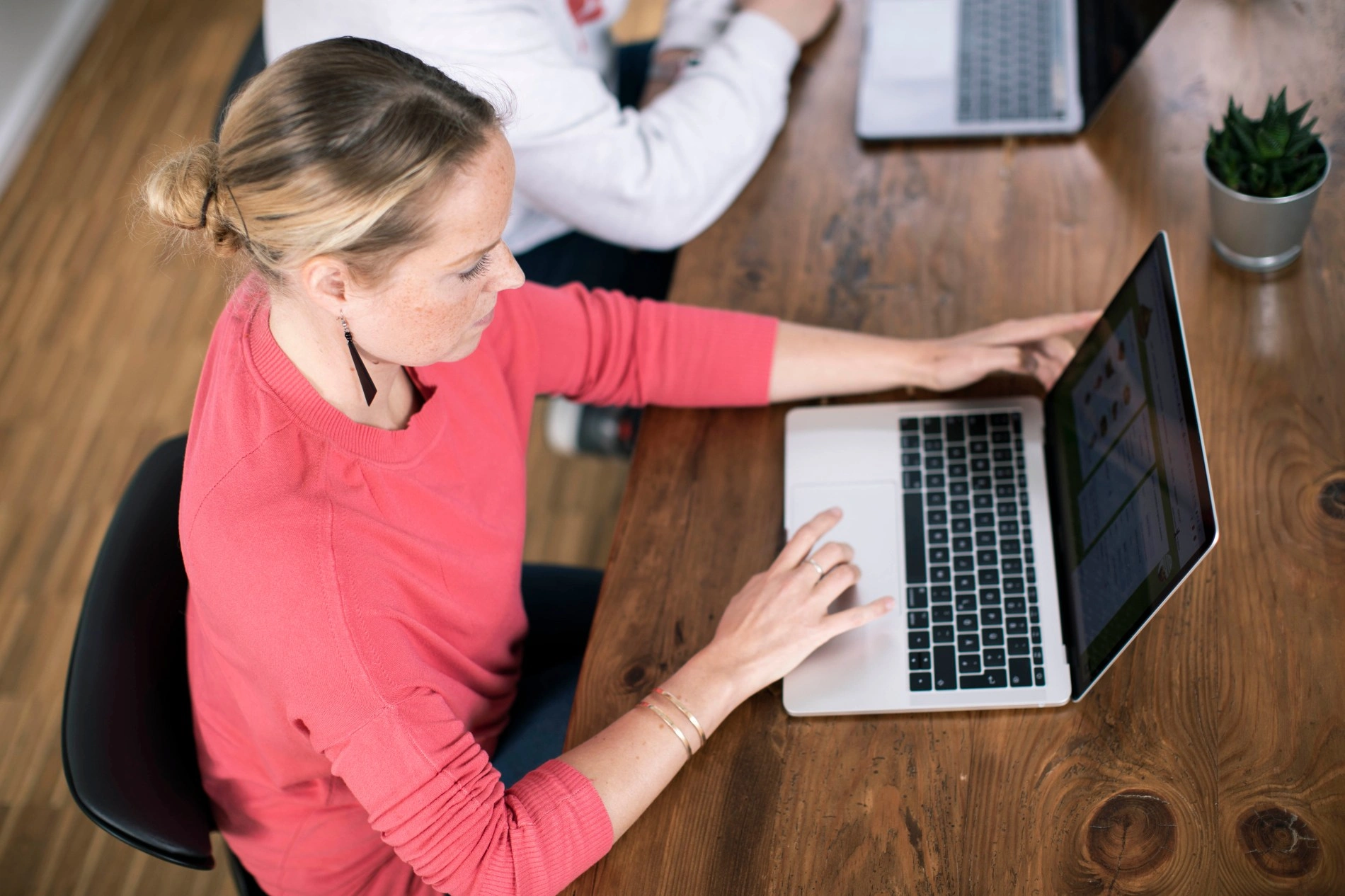 Woman working intently on a laptop.
