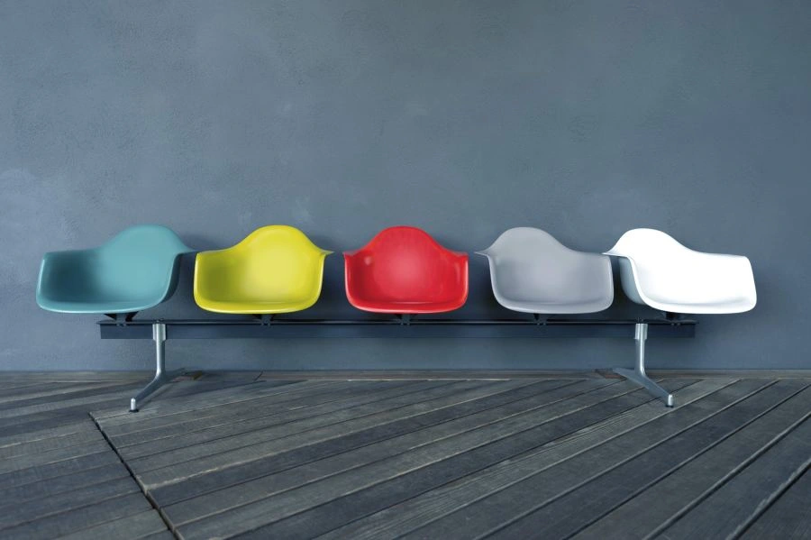 Five chairs with different colors in a row.