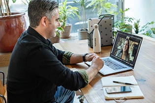 Man in a remote meeting with his team
