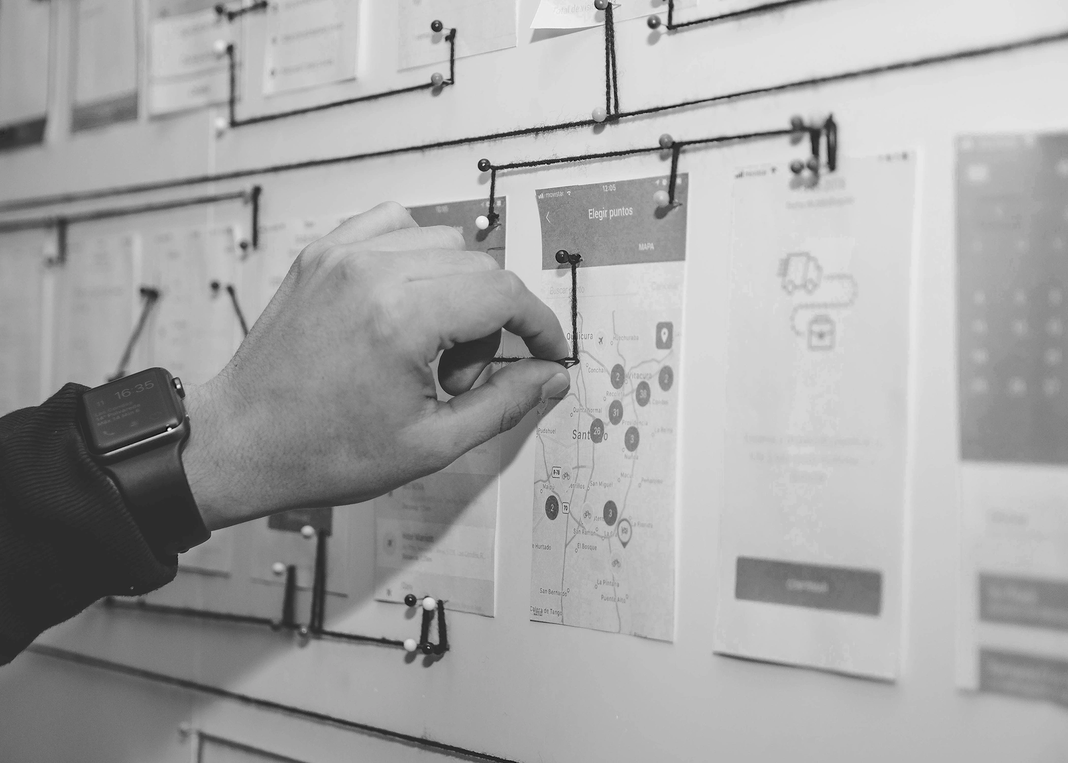 Person working on blue and white paper on board