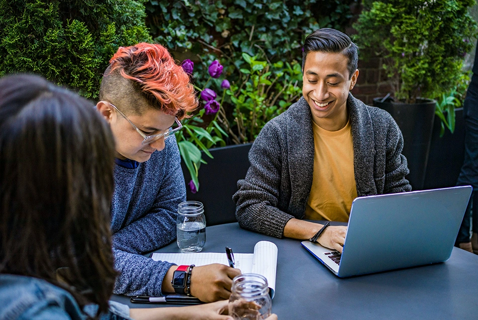 A group of people have a meeting outside