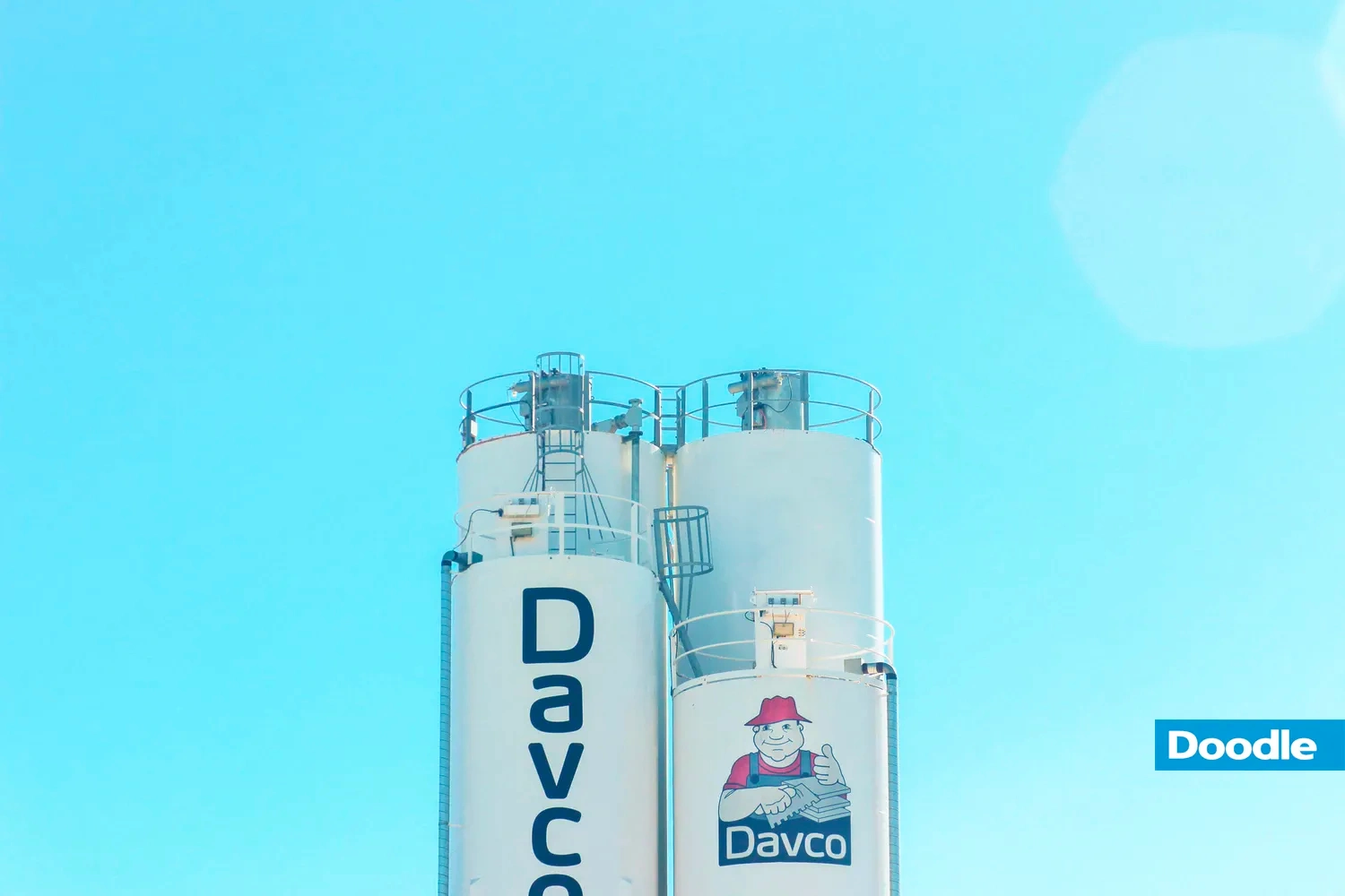 Two white silos and blue sky