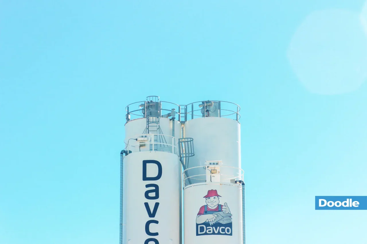 Two white silos and blue sky