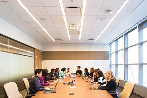 People sitting in a room and held a board meeting