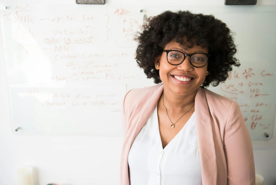 woman smiling by a whiteboard