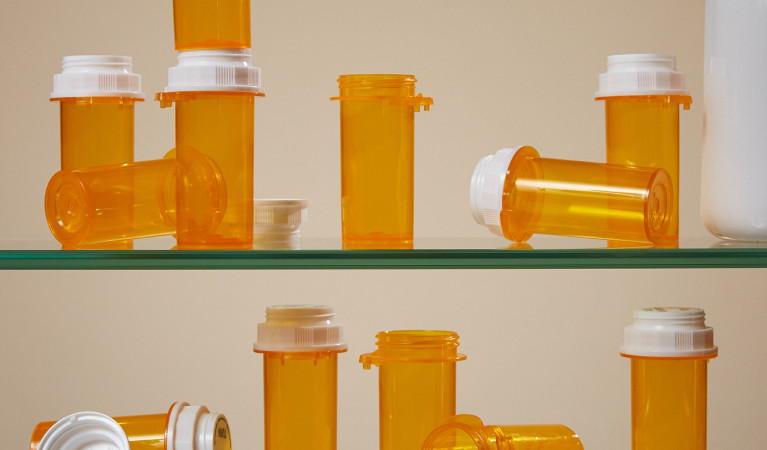 Shelf with orange plastic prescription bottles