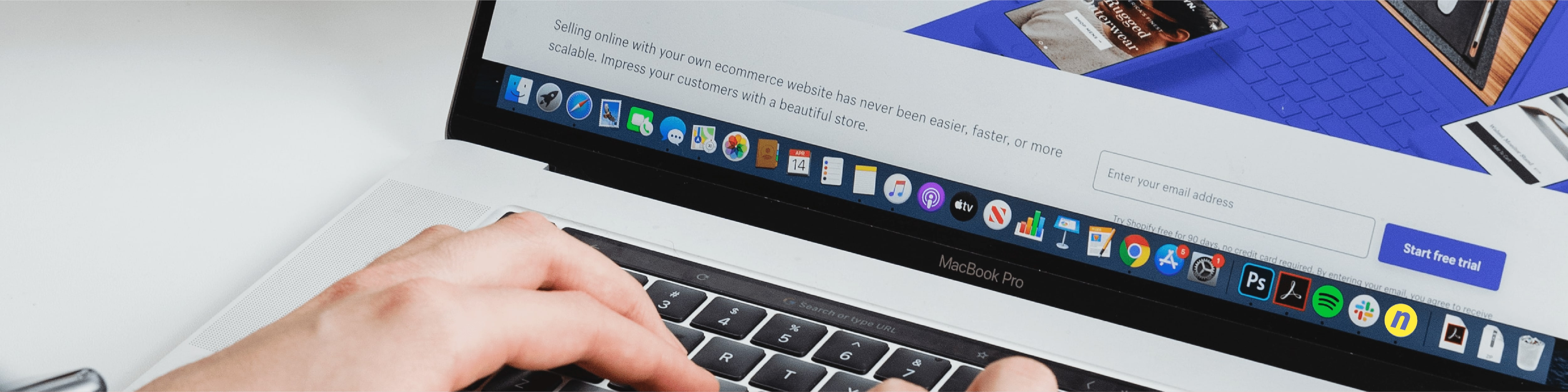 Web marketing banner showing hands typing on a MacBook Pro