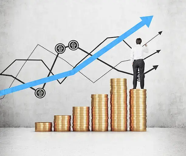 Man standing on piles of coins