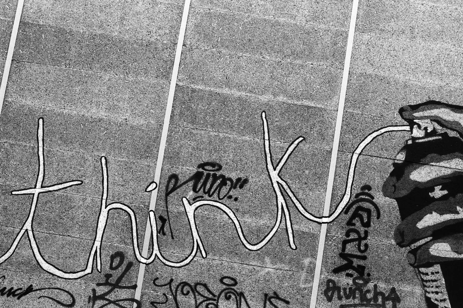 Graffiti with words &quot;think&quot; on the wall, and the words are coming from a spray can.