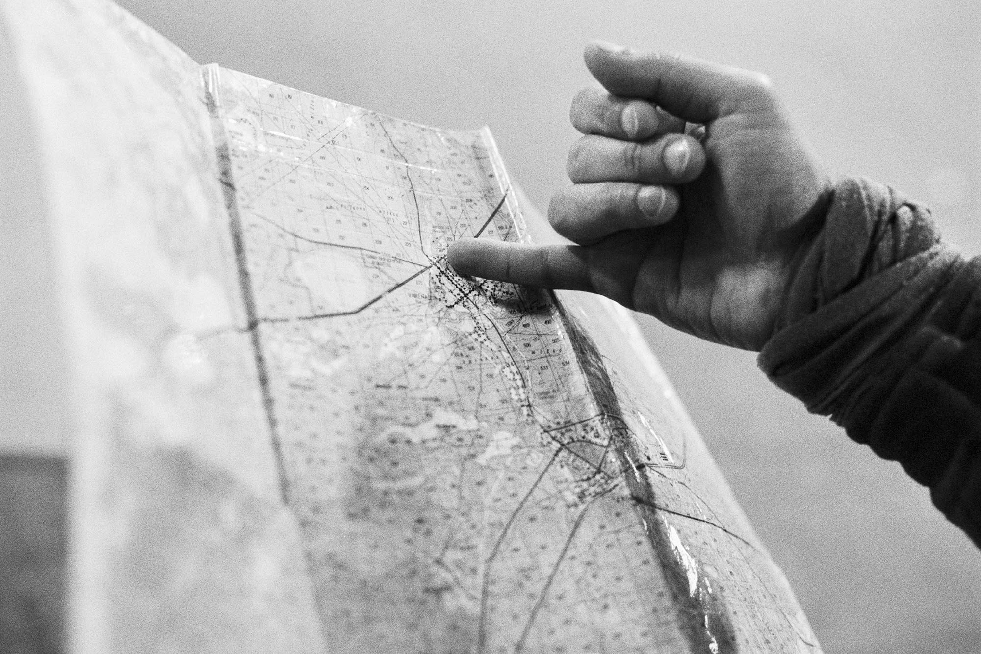 A map and a pinky finger pointing at a location we need to go.