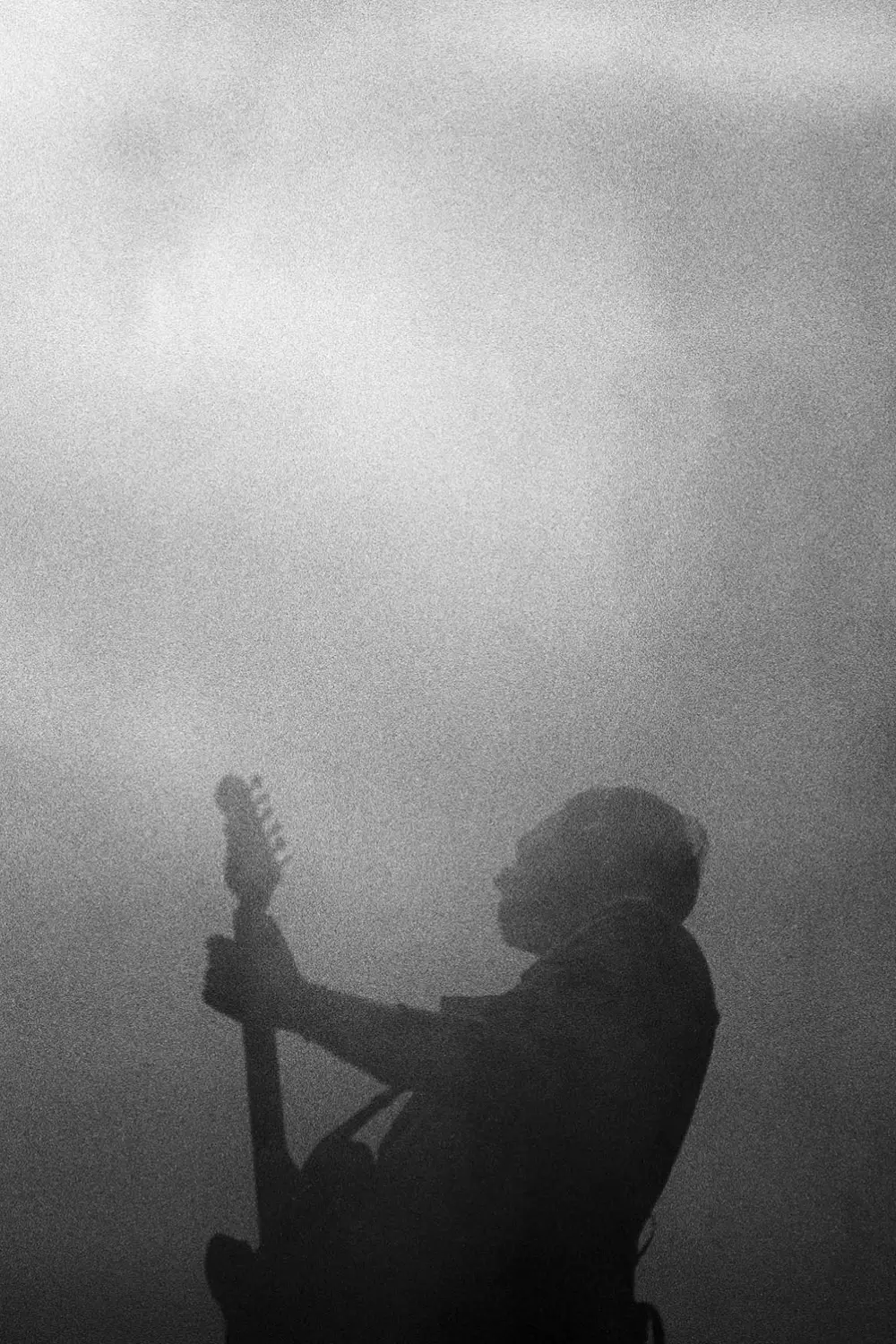 One person playing guitar in front of the audience