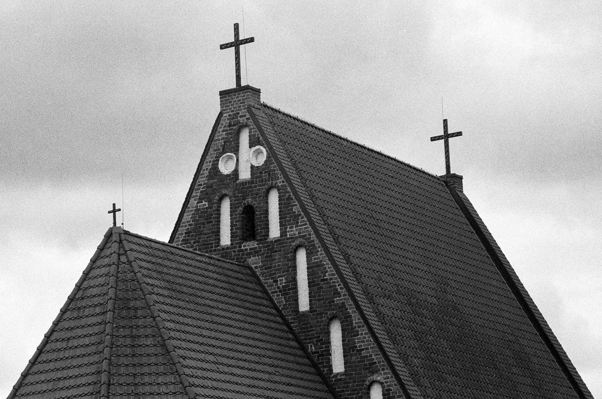 Roof of a church of Zapyškis with three crosses, all different in size.