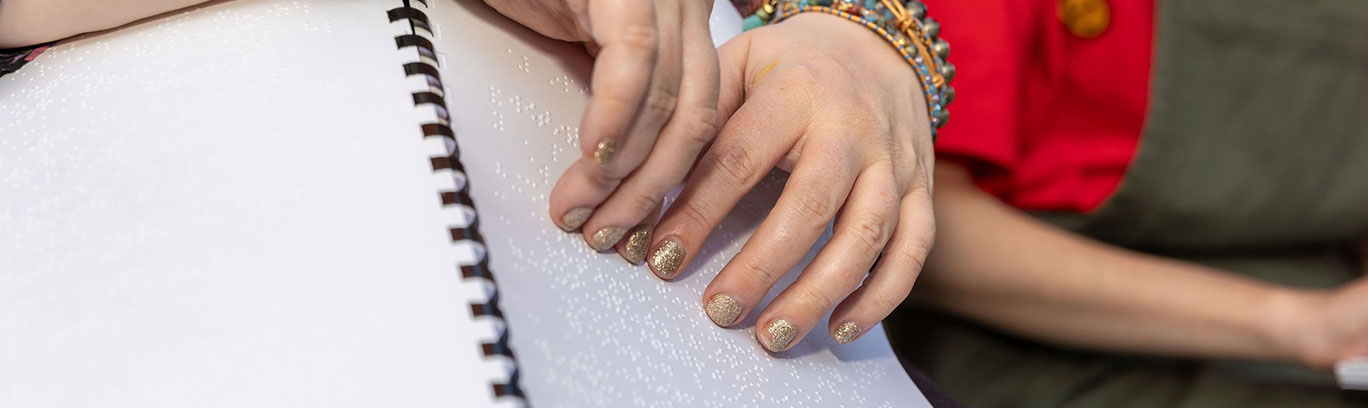 Person using braille songbook