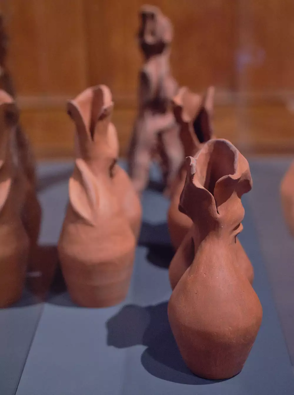 Image shows four terracotta clay pots ontop if a grey plinth