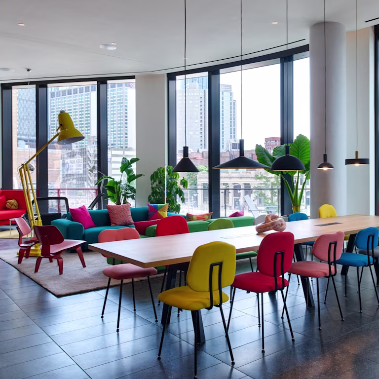 BBB - living room with colourful chairs and long table