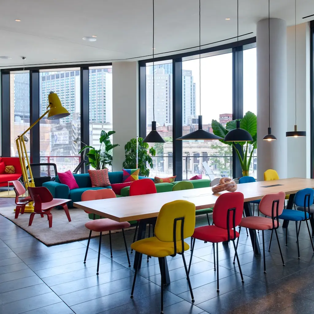 BBB - living room with colourful chairs and long table