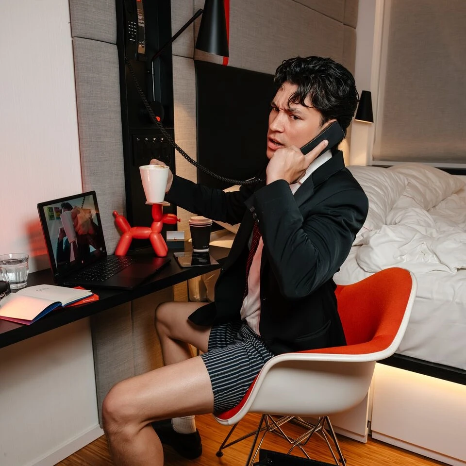 man in shorts on the phone