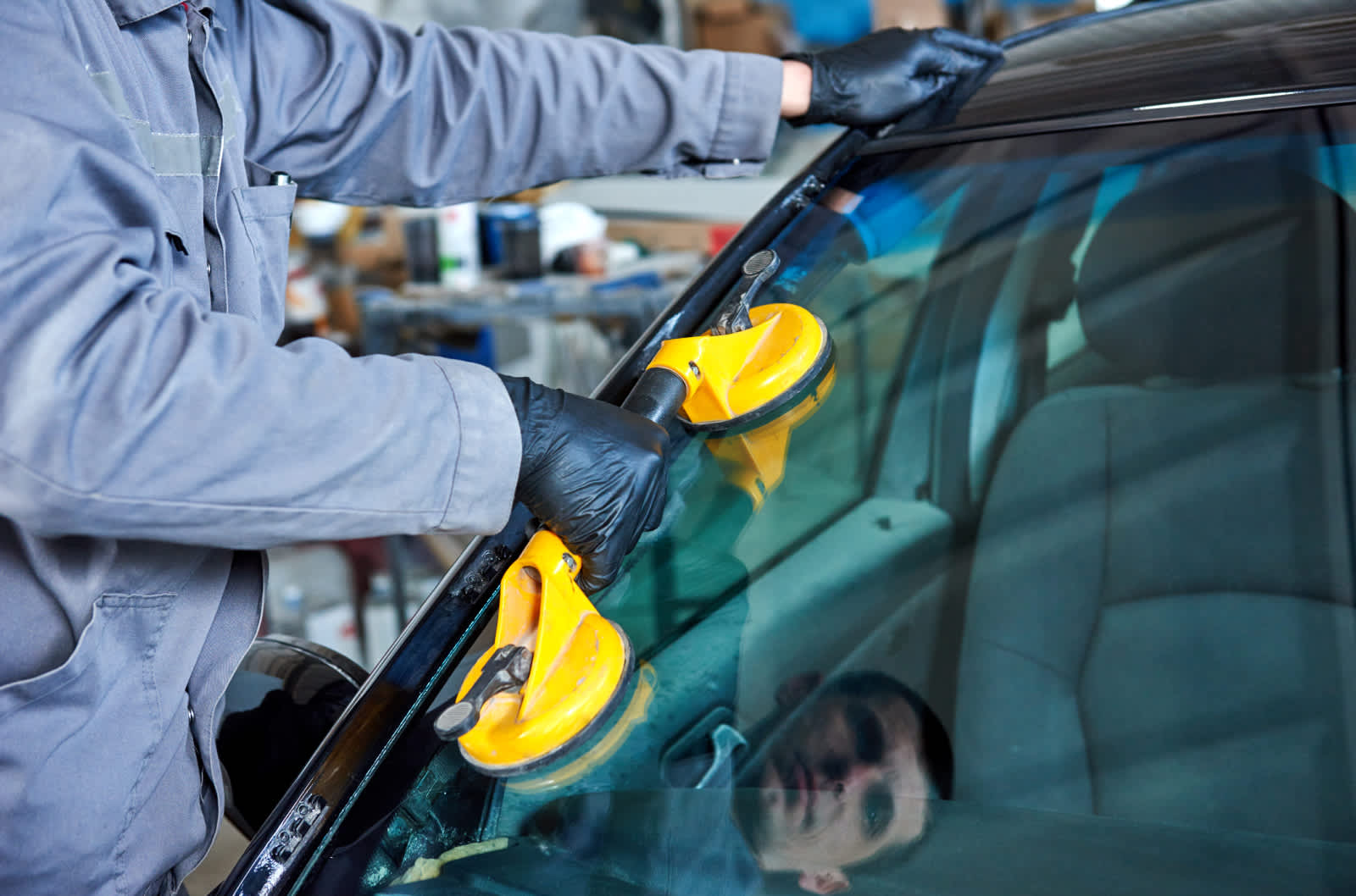 A technician works to repair a windshield