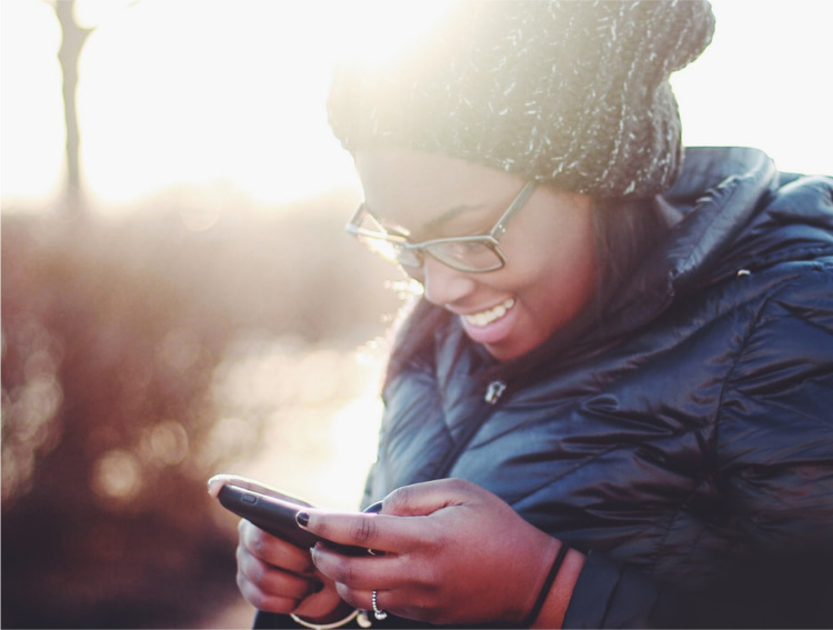 Woman outside looking at smartphone