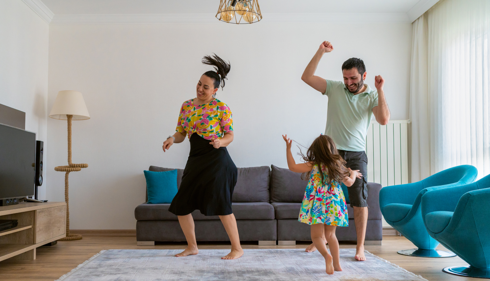 Happy family dancing in the living room