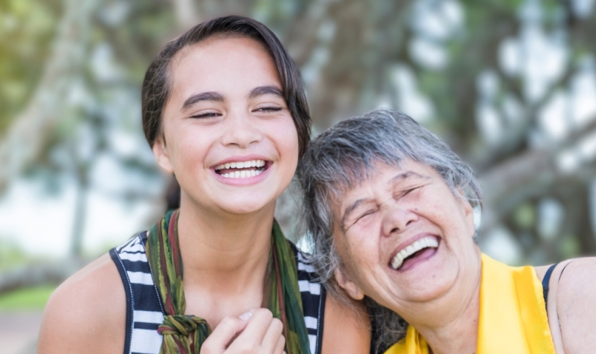 Maori girl with her grandmother smiling in nature