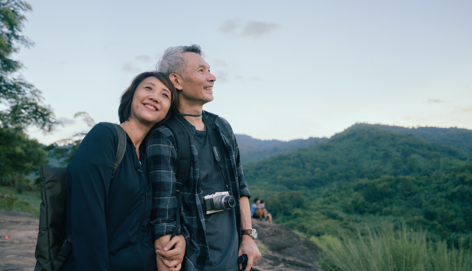Asian couple hiking in the mountains
