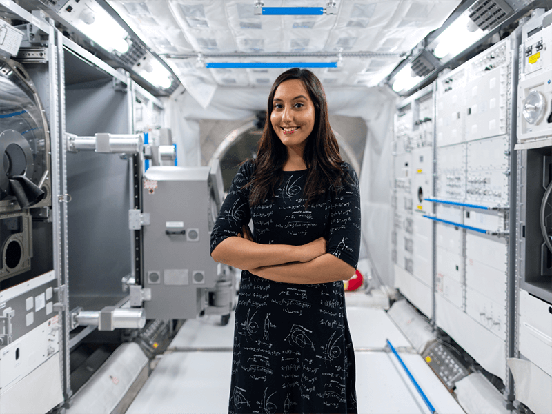 Female engineer at a space station, careers professional, upbeat 