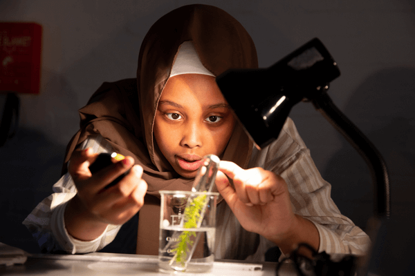 female student conducting a science experiment