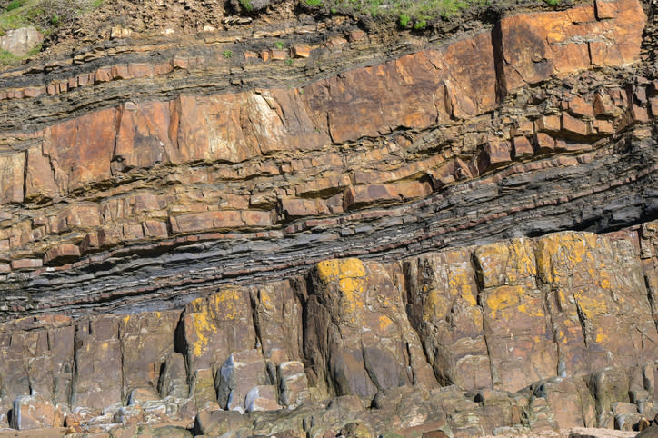 Layers of rock strata on a cliff face.