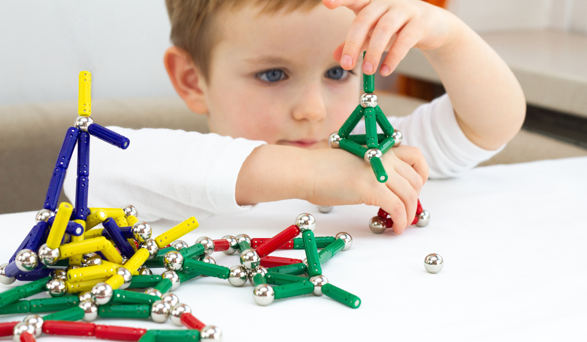 Child playing with toy magnets