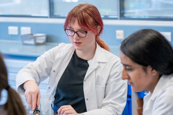 Female ECT teacher carrying out a science practical