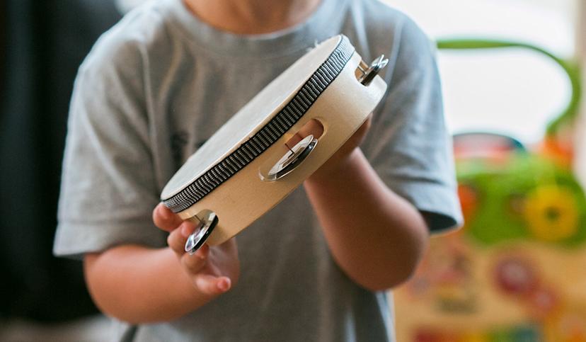Musical instrument - tambourine played by a child