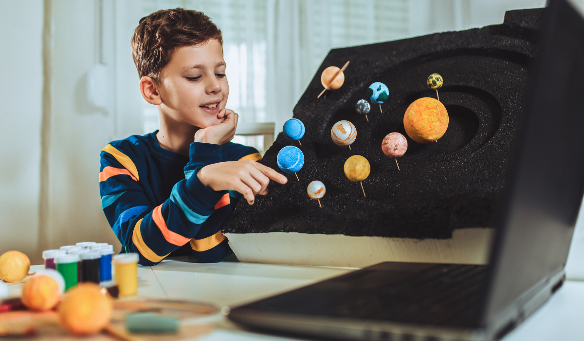 Child creating a model of the galaxy
