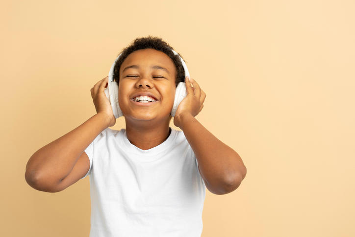 Child listening to music through headphones