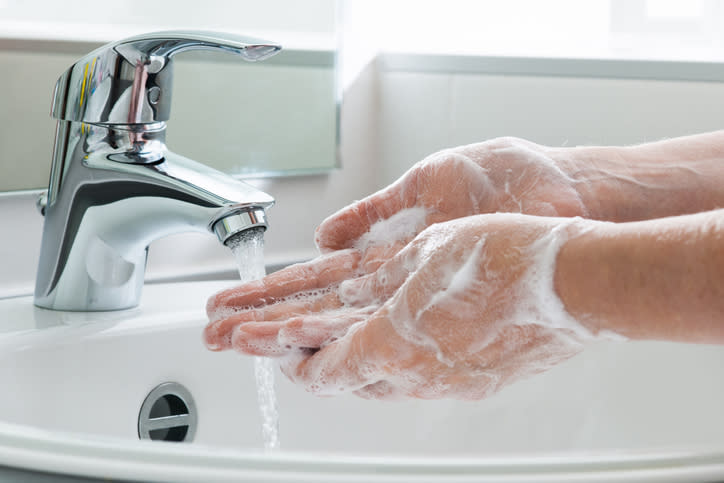 Washing hands under a tap