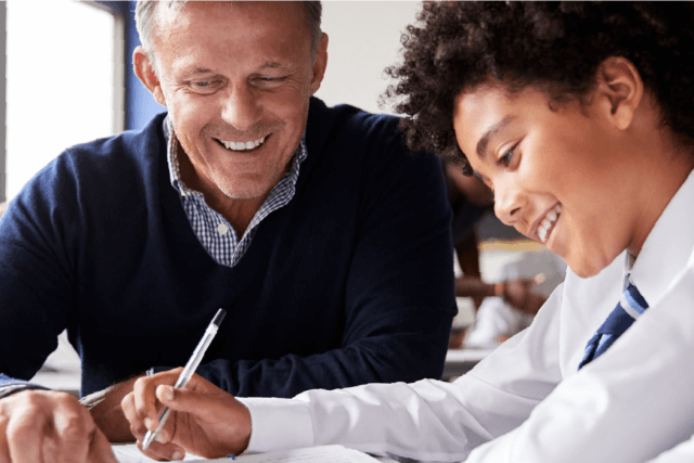 Teacher Helping A Student With A Task