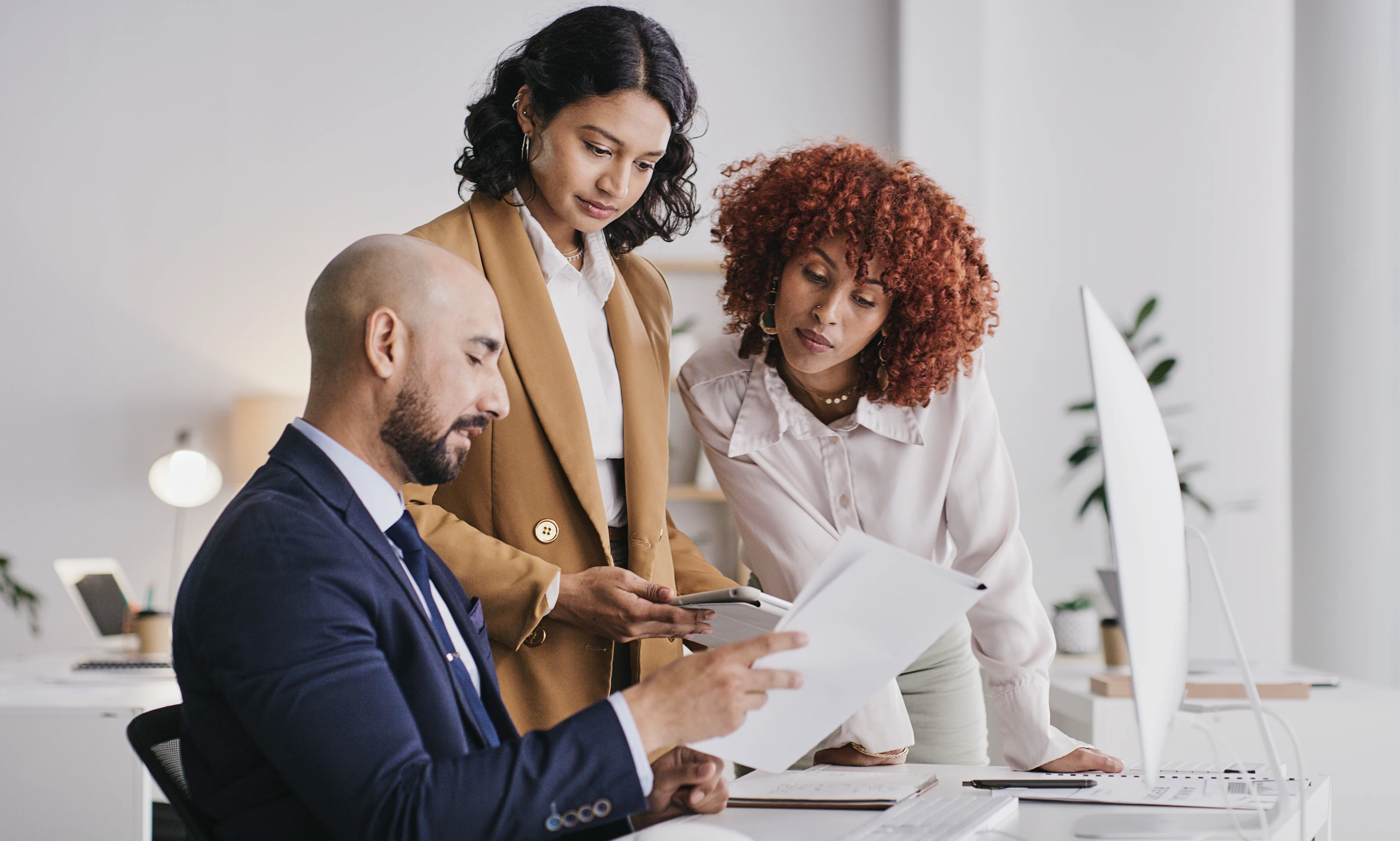 Group of co-workers reviewing reports