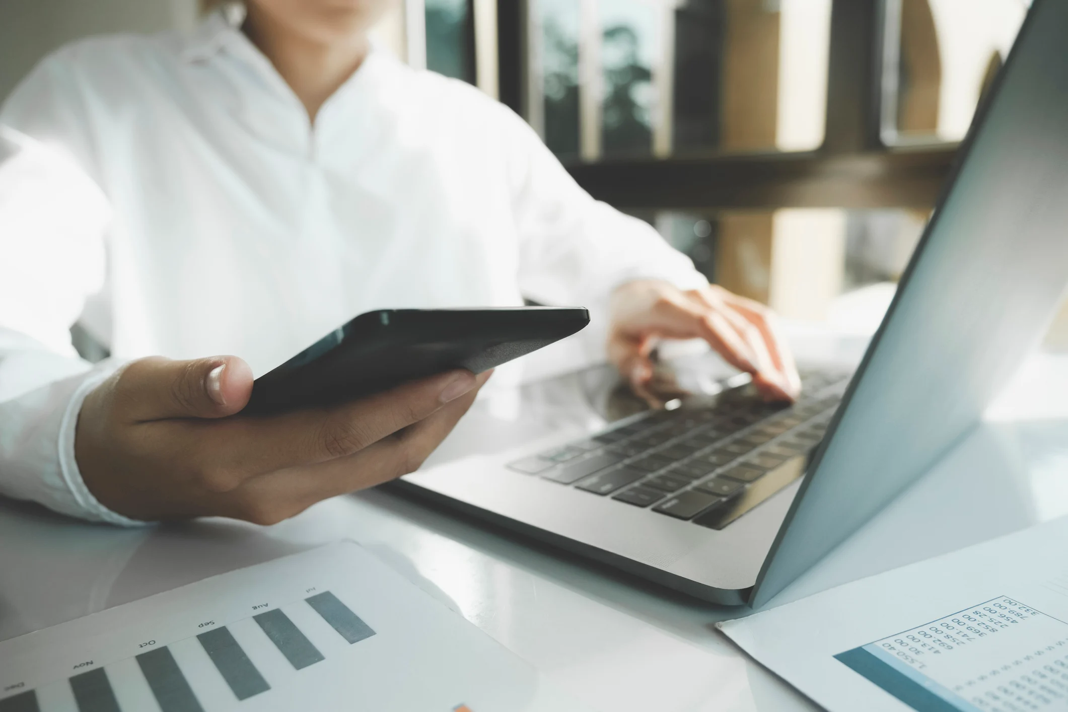 Image - Person looking at laptop and phone