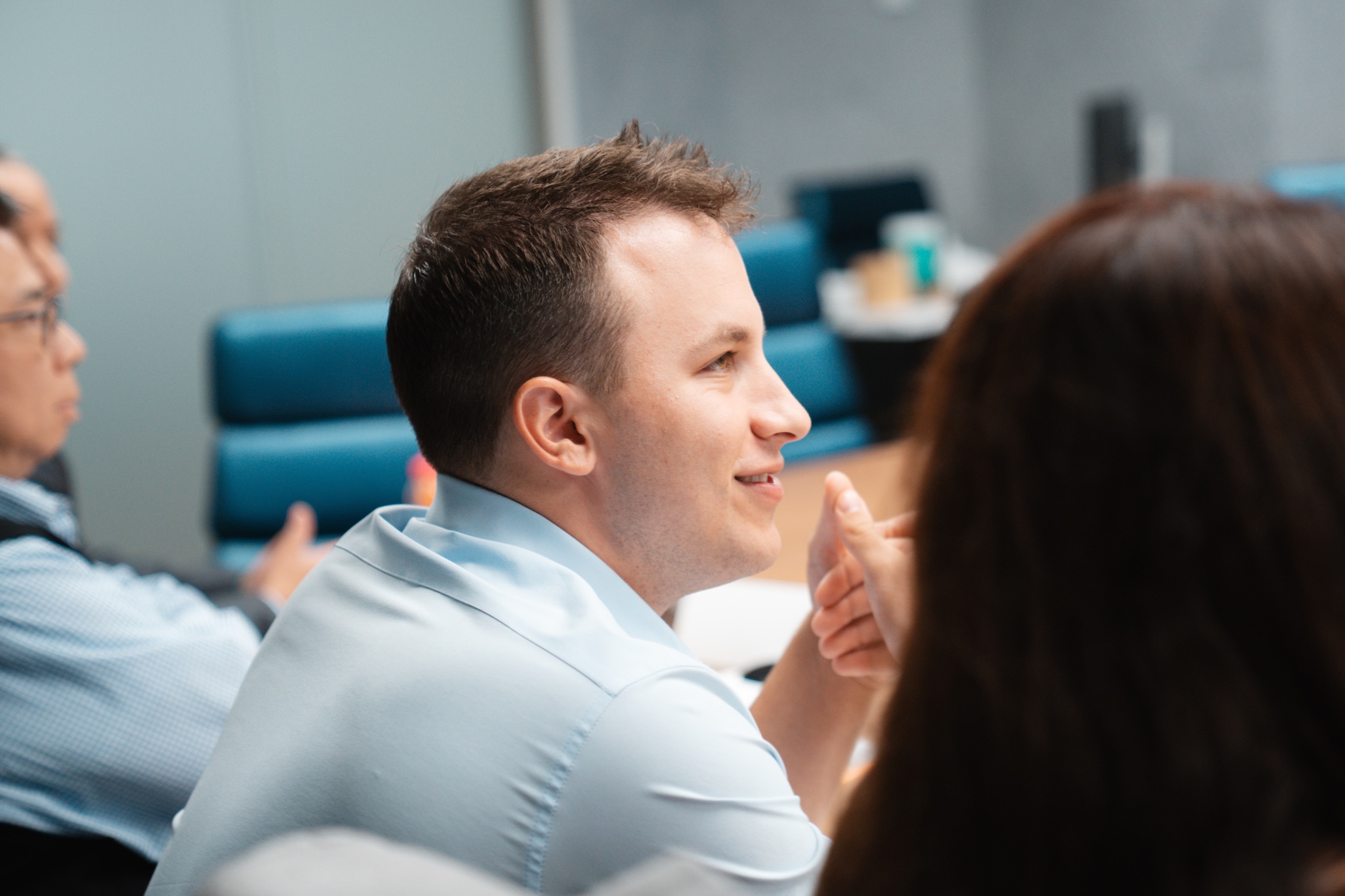 A side view of a happy employee at a conference table