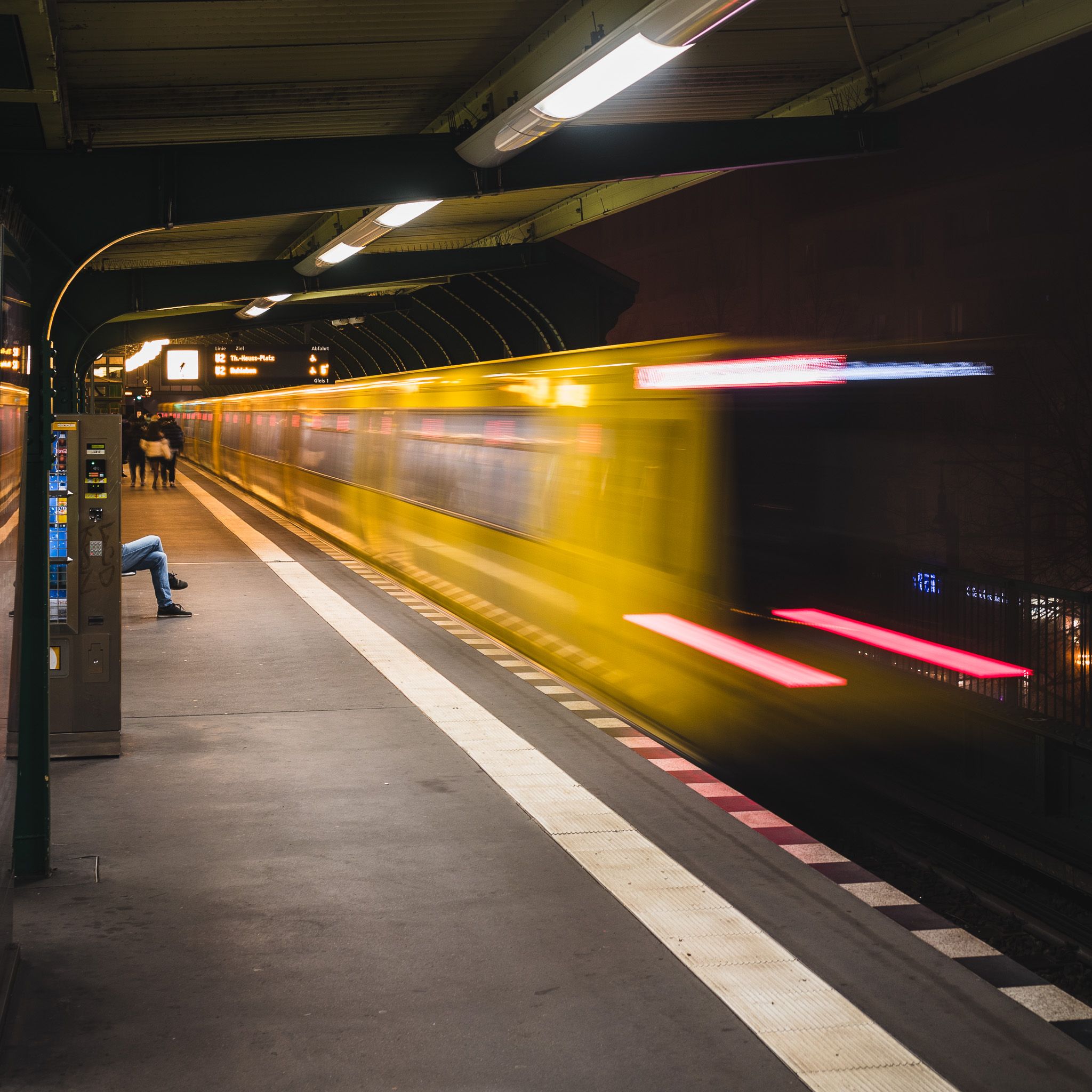 A view from a subway platform as a train whizzes by