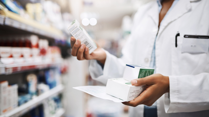 A pharmacist takes inventory of the medications available.