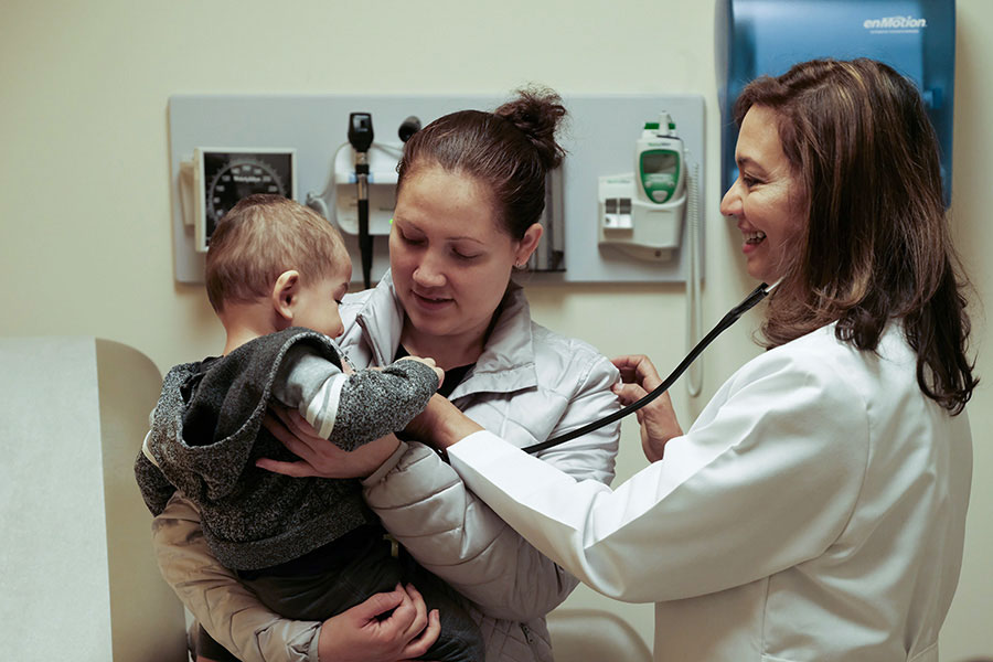 Ligia Peralta caring for infant patient and mother