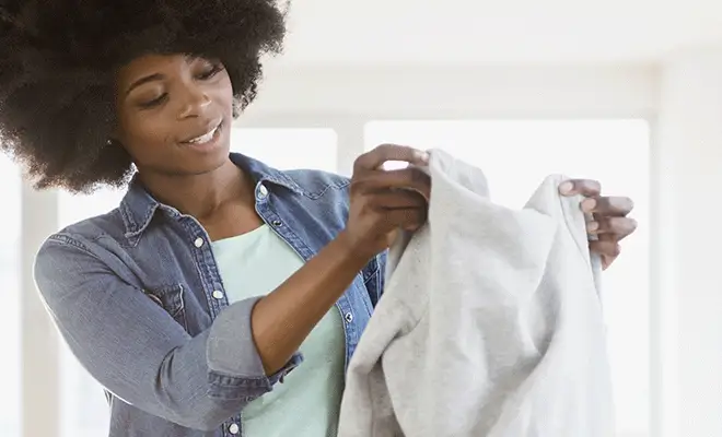 Women holding up a sweatshirt Women holding up a sweatshirt