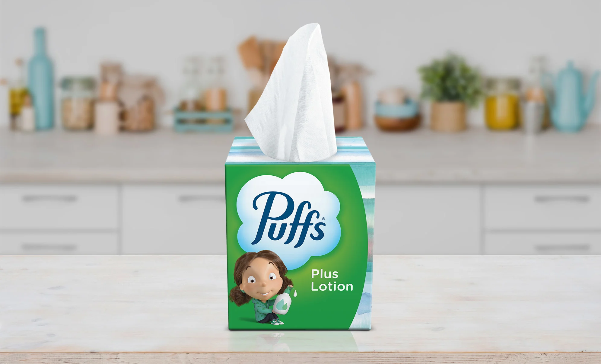Girl sitting at the table with Puffs Plus Lotion