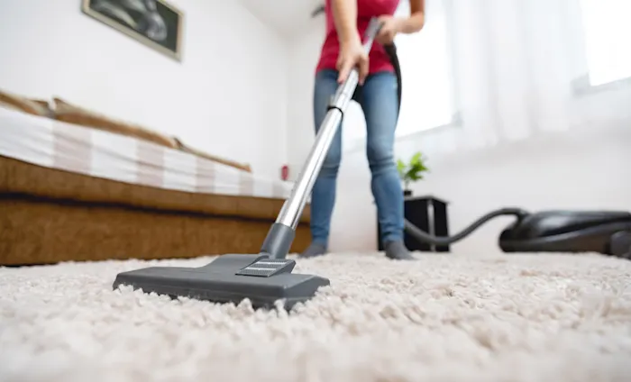 Woman vacuuming carpet