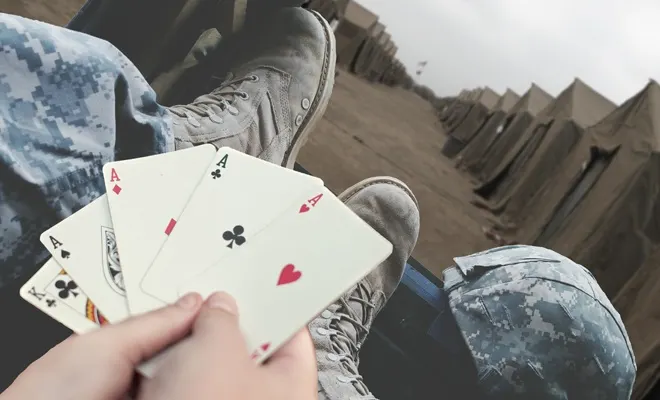 Holding playing cards with a 4 of a kind of aces