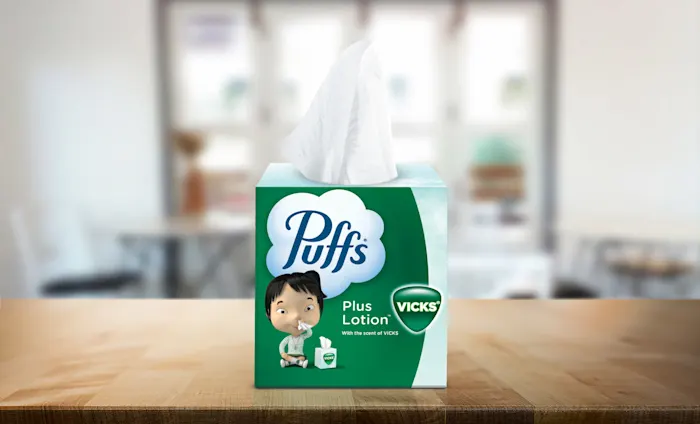Puffs Plus Lotion with the Scent of Vicks on counter