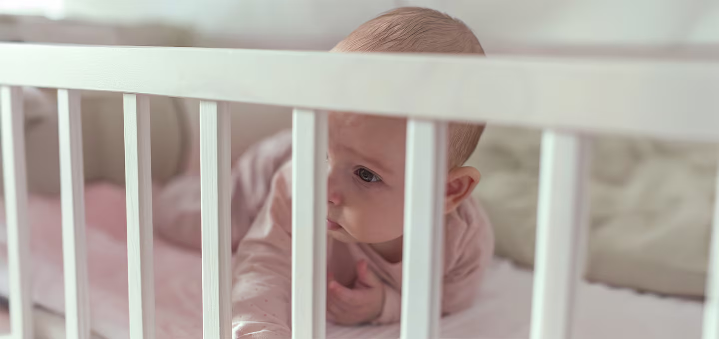 Baby in crib during Ferber Method sleep training
