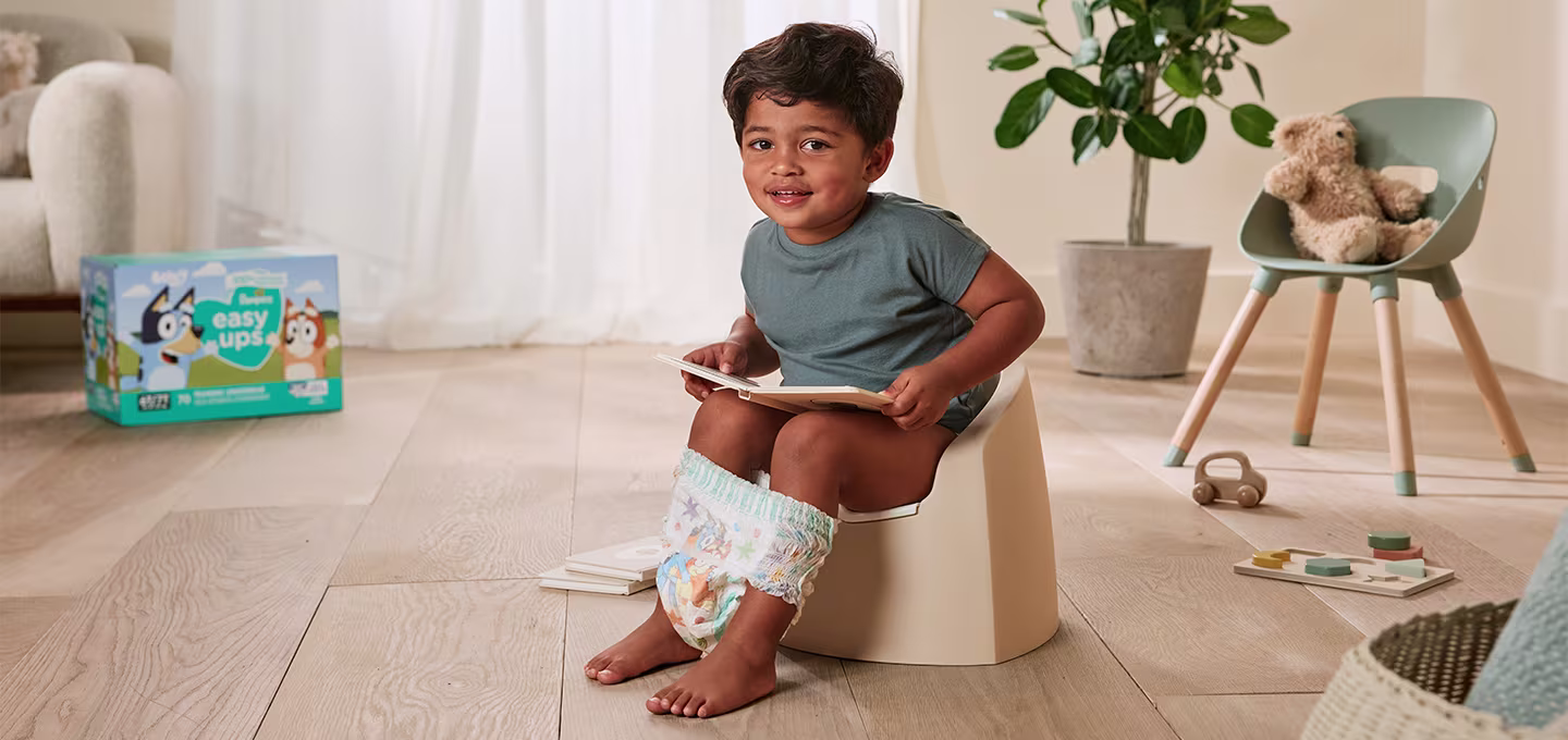 A toddler sitting on a potty