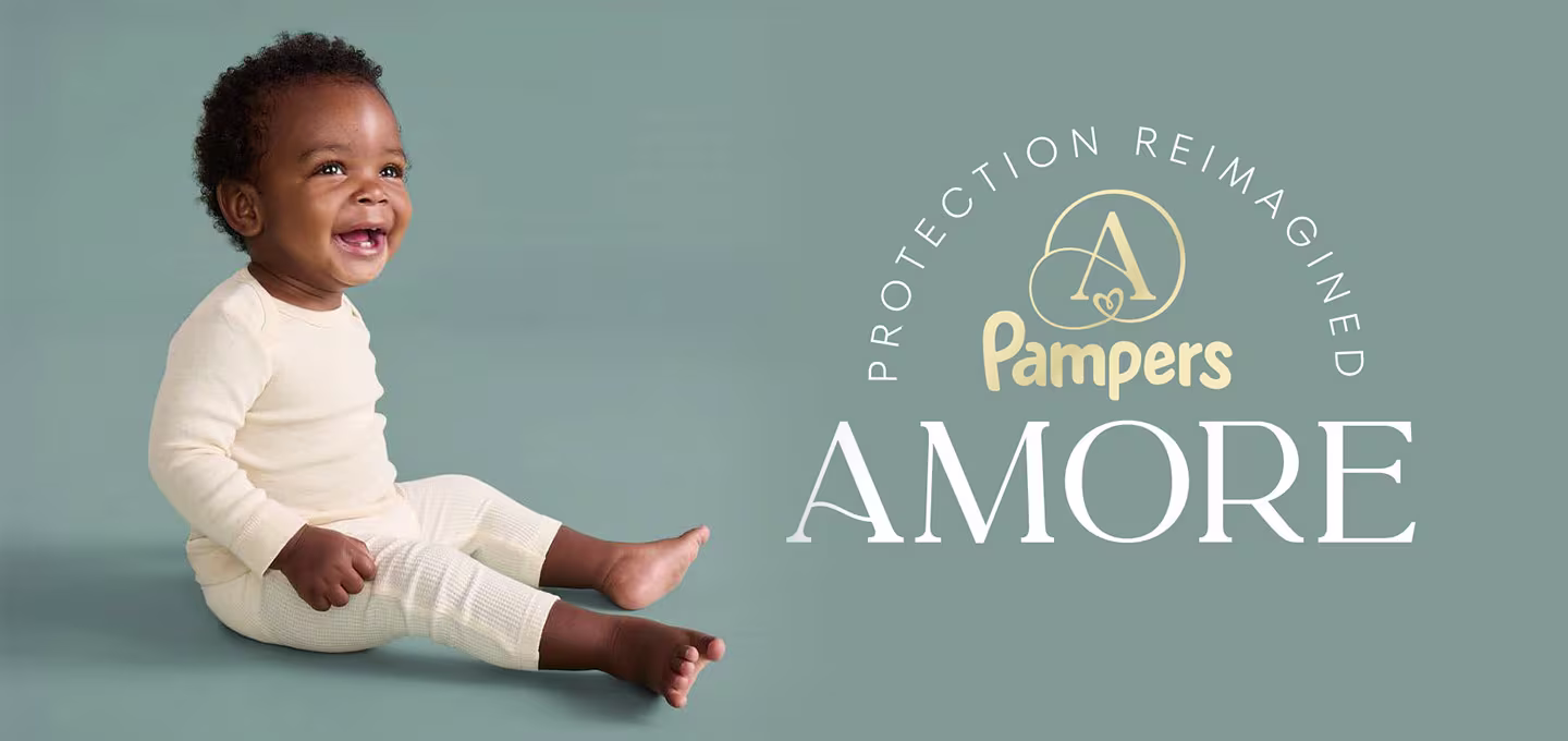Smiling baby in a neutral-toned diaper, illustrating everyday comfort with Pampers AMORE diapers.